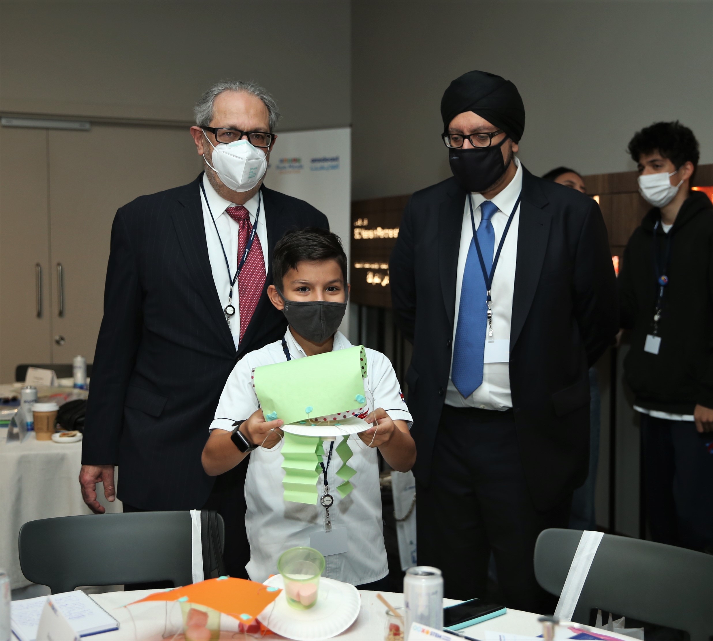 Ambassador Theodore H. Kattouf with Boeing META President Kuljit Ghata-Aura and a young learner.