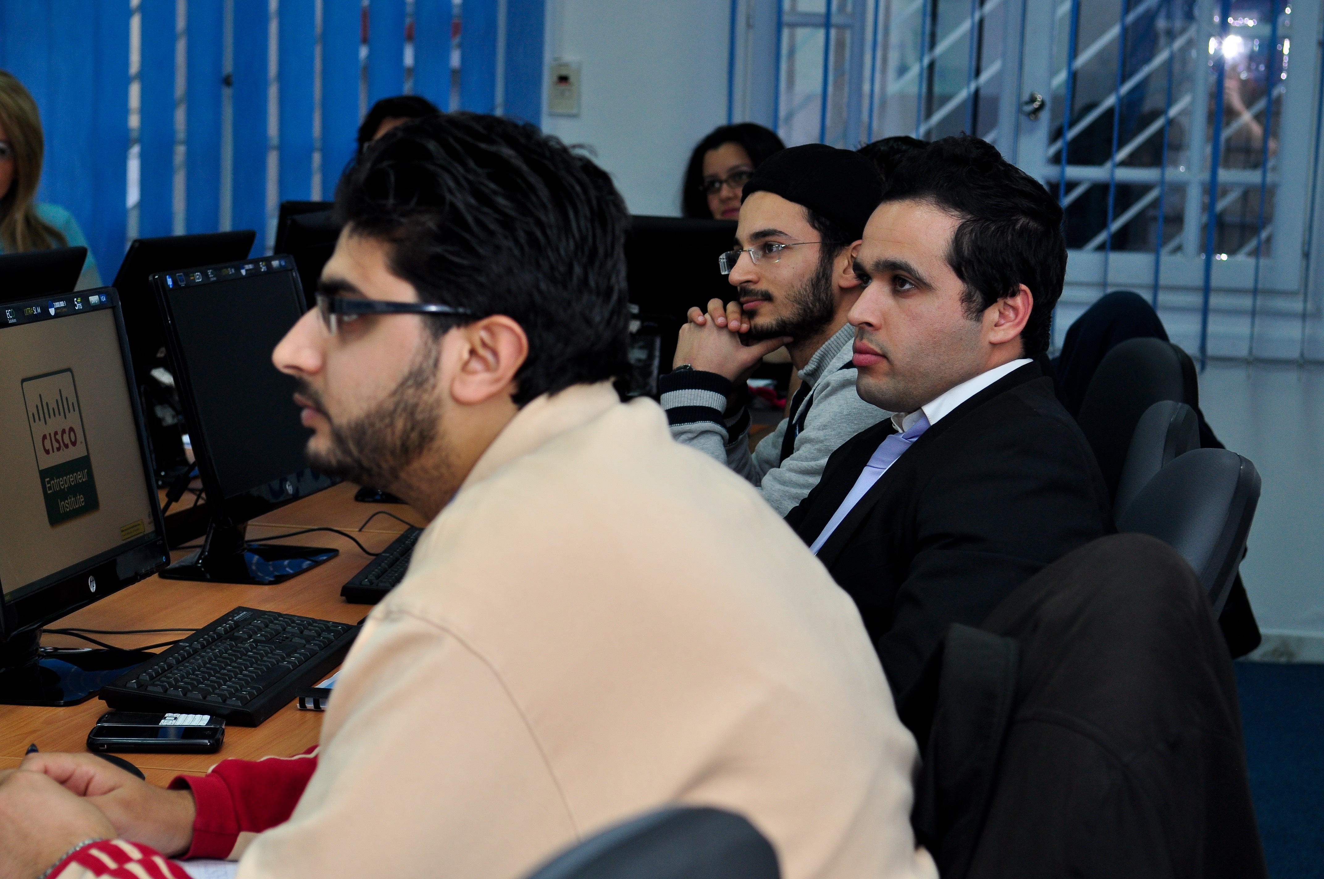 company staff look attentively towards their teacher who is offscreen 