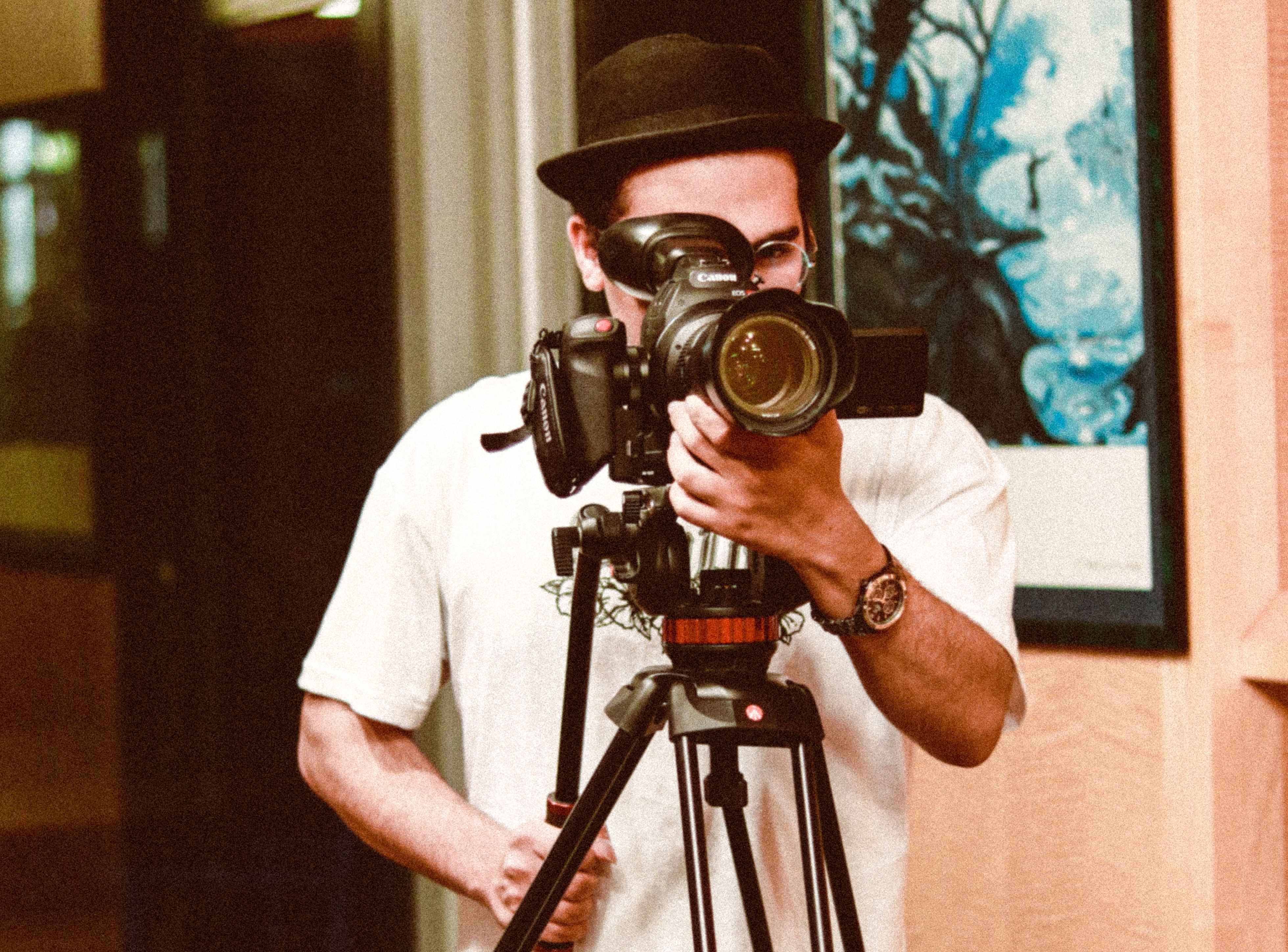 Omar standing behind his camera