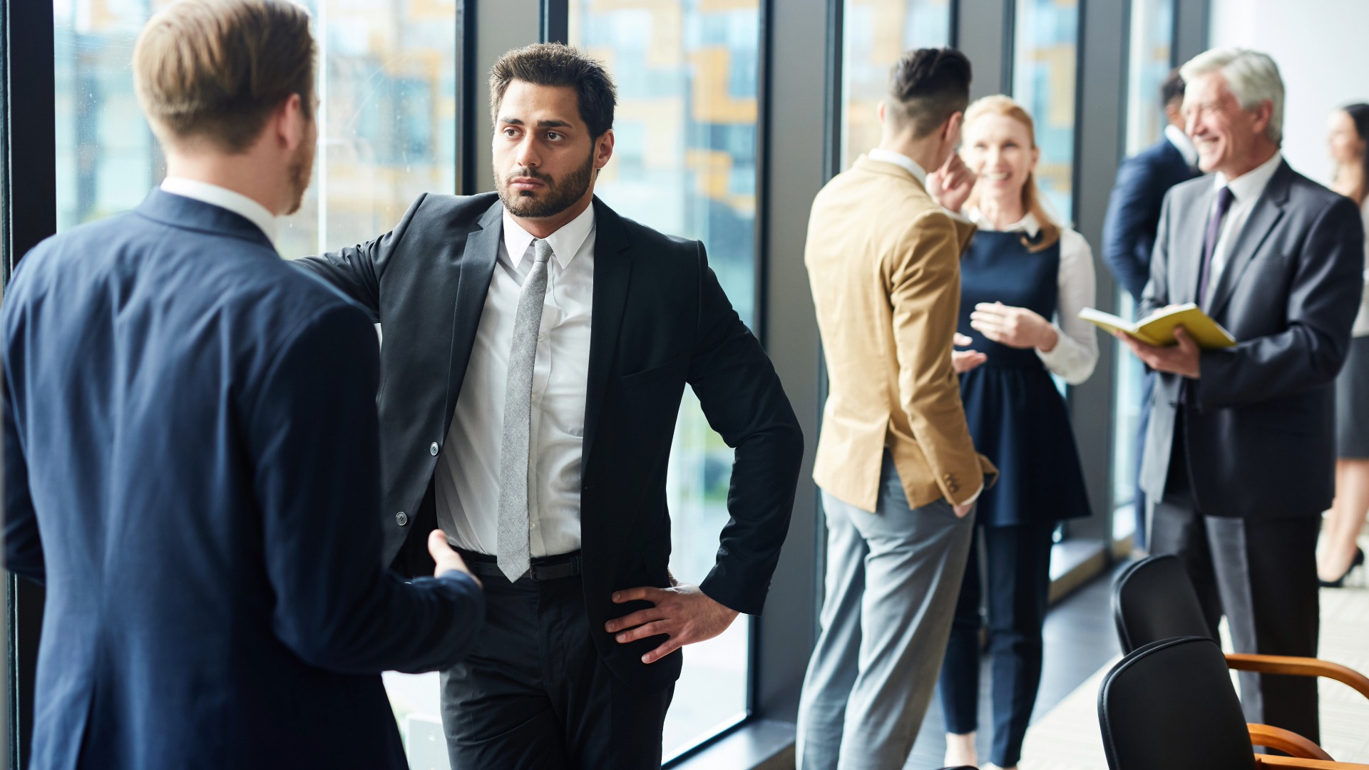Confident delegate debating with audience or opponent by tribune at political conference
