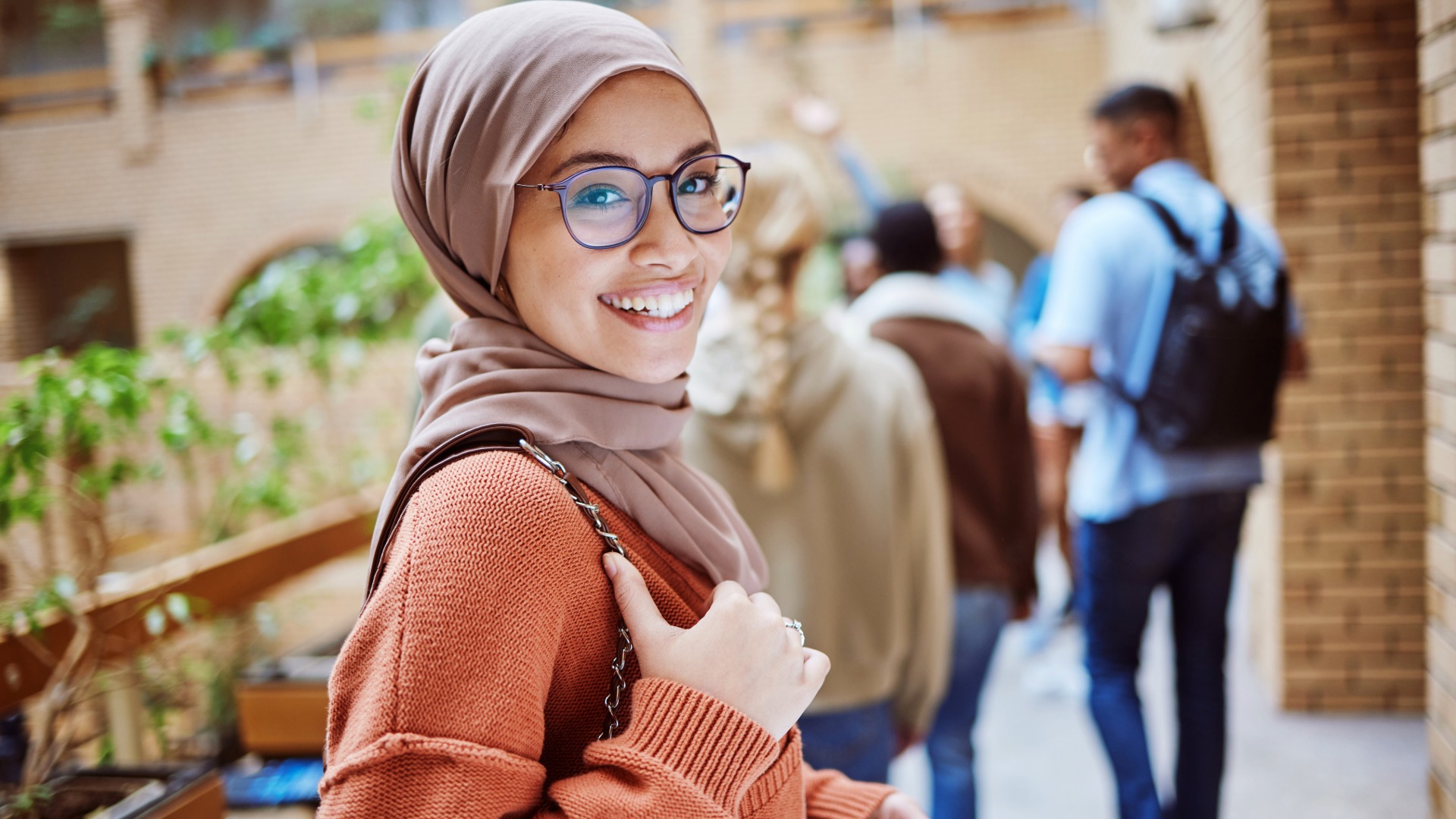 Portrait, muslim or happy woman on university, school or college campus and education, learning or studying goals. Smile, face or Islamic student with hijab scarf, international scholarship or vision