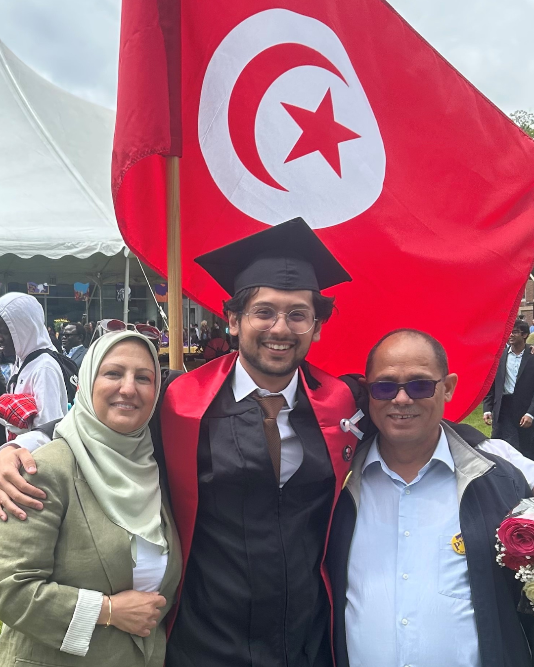 Ashraf poses with his parents on his graduation.