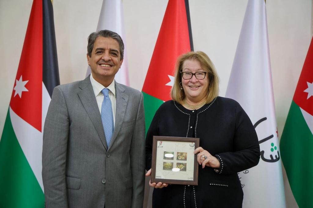 Minister and Ambassador in front of flags