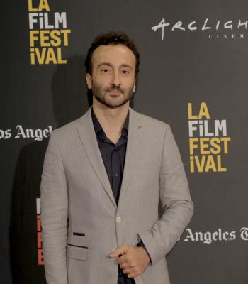Man standing in front of black LA Film Festival backdrop