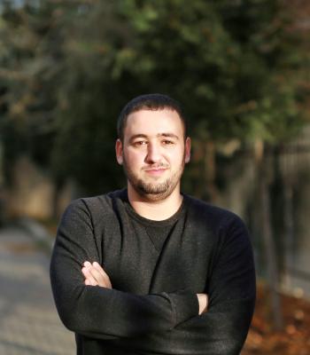Mourad smiling outside 