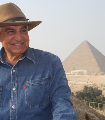 Dr. Zahi smiling in front of the Pyramids in Egypt