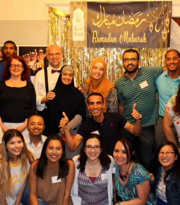 Group photo in front of Ramadan Kareem Banner