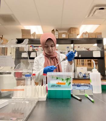 A woman doing lab work. 