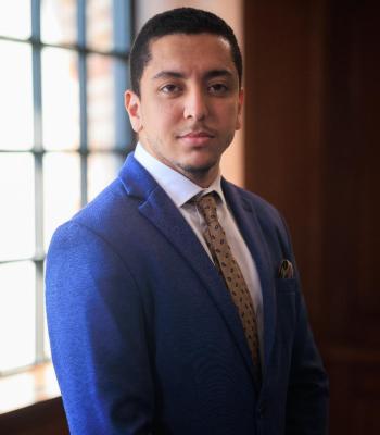 Headshot of a man in a suit.