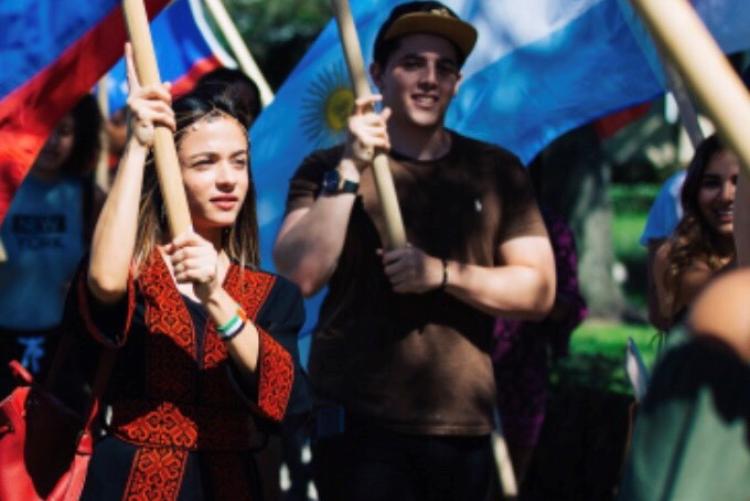 Two students holding up signs 