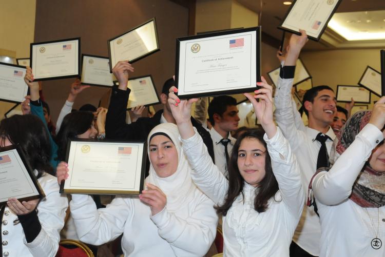 Group of Access students holding certificates in the air