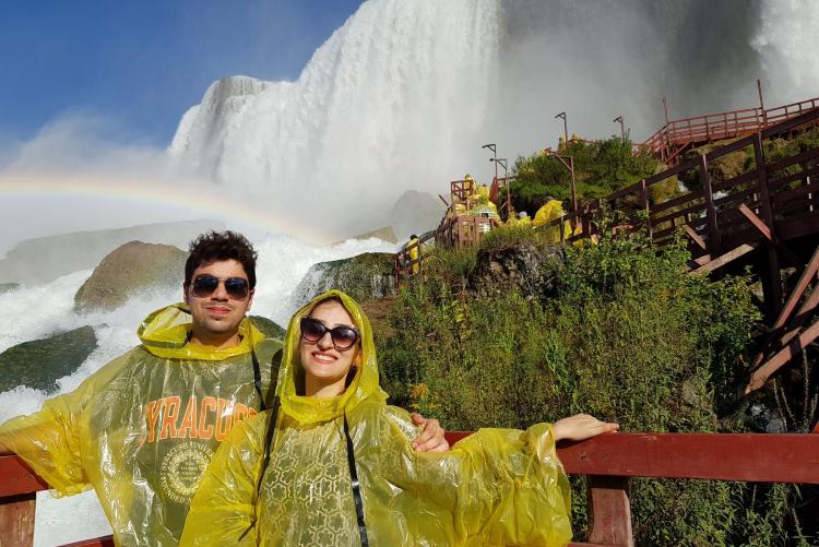 Two students in front of a waterfall