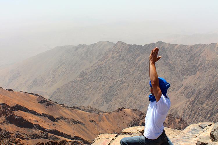 A student doing a yoga pose on Mount Toubkal in Morocco
