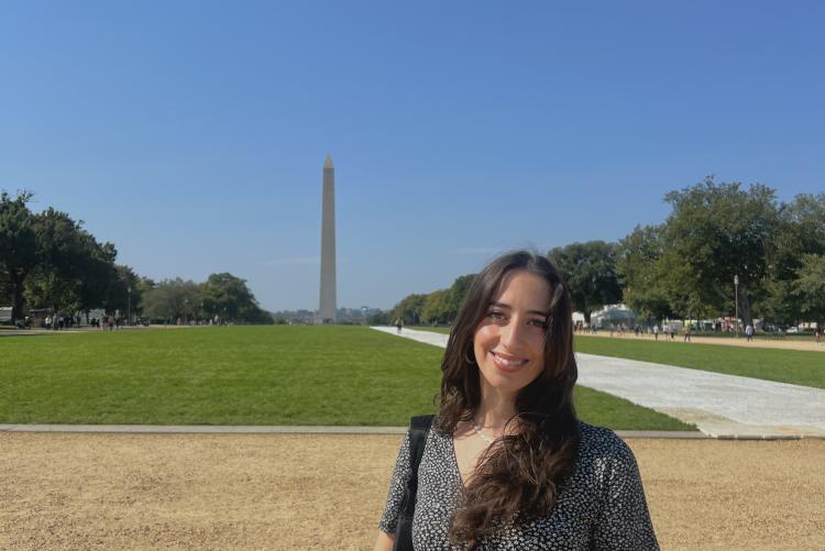 Student in front of the Washington monument. 