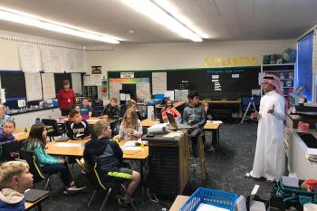 Picture of Saudi exchange student teaching American grade school youth about Saudi Arabia