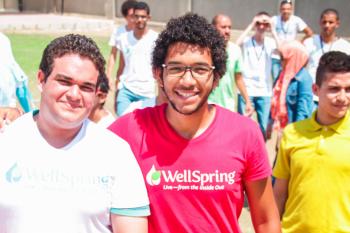Male students in the HEI program smile at the camera