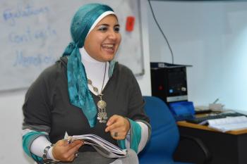 Teacher smiles while leading class
