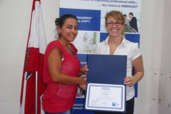 Two women hold up CAPM certificate