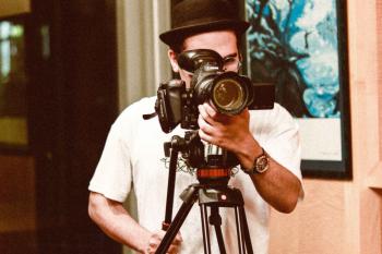 Omar standing behind his camera