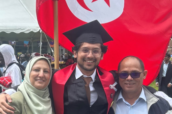 Ashraf poses with his parents on his graduation.
