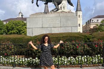 Girl posing in front of monument.