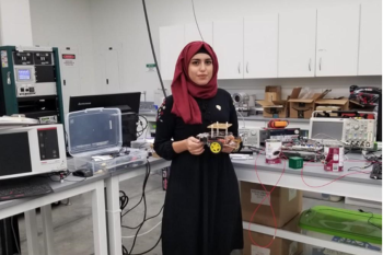Woman holding a robot.