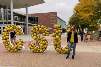 Woman next to CSU structure.