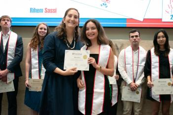 Rihem posing with certificate