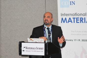 A man is presenting at a Materials Summit. 